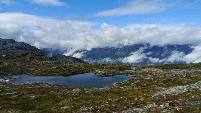 Hardangervidda med innsjø, fjell og skyer.